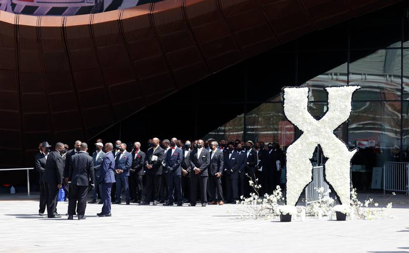 Members of the Nation of Islam are seen next to an X floral arrangement outside the Barclays Centre where a private memorial for US rapper DMX is being held in Brooklyn, New York. EPA
