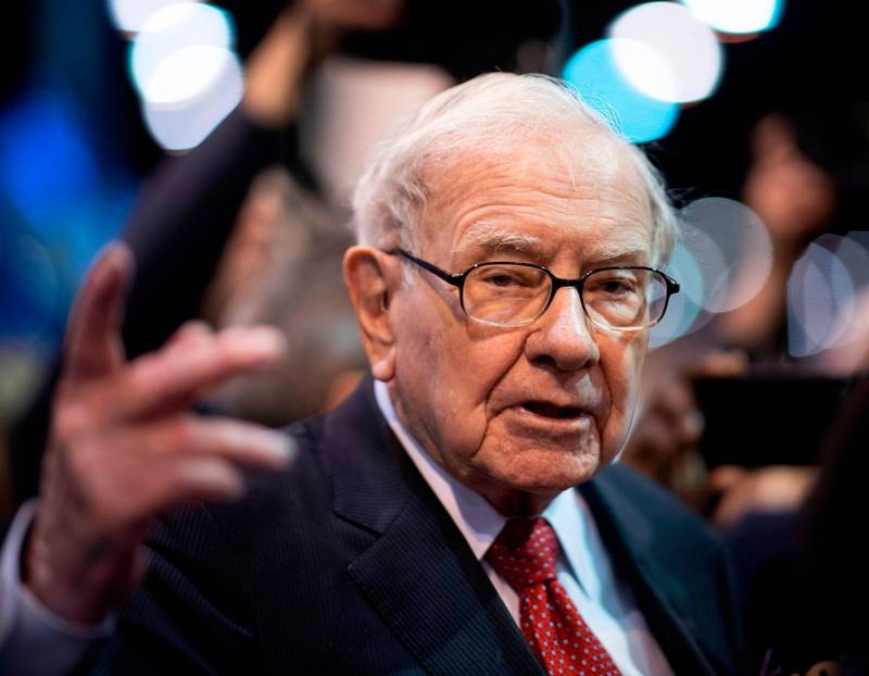 (FILES) In this file photo taken on May 04, 2019, Warren Buffett, CEO of Berkshire Hathaway, speaks to the press as he arrives at the 2019 annual shareholders meeting in Omaha, Nebraska. Berkshire Hathaway, the holding company of Warren Buffett, bought back approximately $5.1 billion of its own shares in the second quarter as it was hit hard by economic fallout from the coronavirus pandemic. Berkshire's net profit climbed to $26.3 billion, up sharply from $14.1 billion in the same period last year.  / AFP / Johannes EISELE
