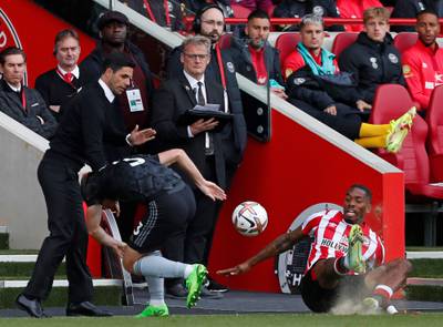 Arsenal manager Mikel Arteta reacts as Kieran Tierney and Brentford's Ivan Toney crash off of the pitch. AFP