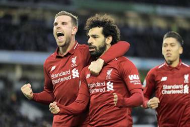 BRIGHTON, ENGLAND - JANUARY 12: Mohamed Salah of Liverpool celebrates with team mate Jordan Henderason of Liverpool after scoring their first goal from the penalty spot during the Premier League match between Brighton & Hove Albion and Liverpool FC at American Express Community Stadium on January 12, 2019 in Brighton, United Kingdom. (Photo by Bryn Lennon/Getty Images)
