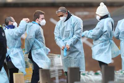 Medical workers are seen at a Government Commission tower which remains under strict lockdown in Melbourne, Australia. EPA