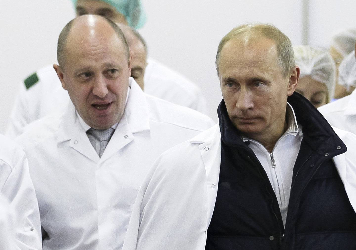 FILE - In this Monday, Sept. 20, 2010 file photo, businessman Yevgeny Prigozhin, left, shows Russian President Vladimir Putin, around his factory which produces school means, outside St. Petersburg, Russia. One of those indicted in the Russia probe is a businessman with ties to Russian President Vladimir Putin. Prigozhin is an entrepreneur from St. Petersburg who's been dubbed "Putin's chef" by Russian media. His restaurants and catering businesses have hosted the Kremlin leader's dinners with foreign dignitaries. (Alexei Druzhinin, Sputnik, Kremlin Pool Photo via AP, File)