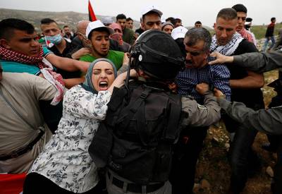 Palestinians try to prevent Israeli troops from detaining a protester at a protest marking Land Day in the West Bank village of Madama, near Nablus. Mohamad Torokman / Reuters / March 30, 2017