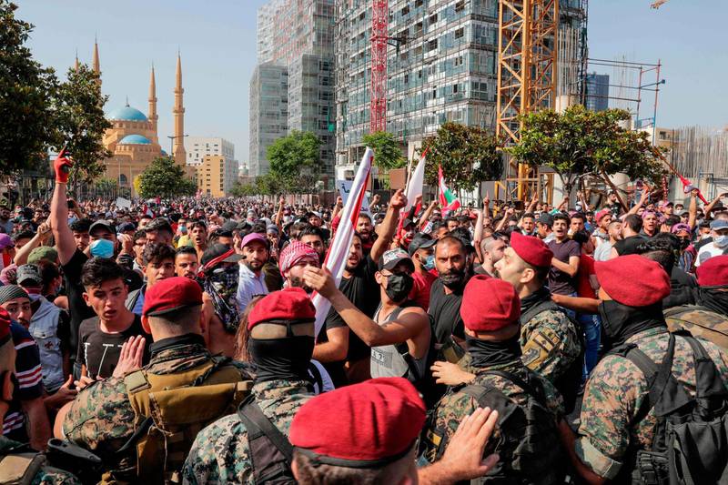 Lebanese soldiers stand guard as protesters shout slogans during the demonstration in central Beirut.  AFP