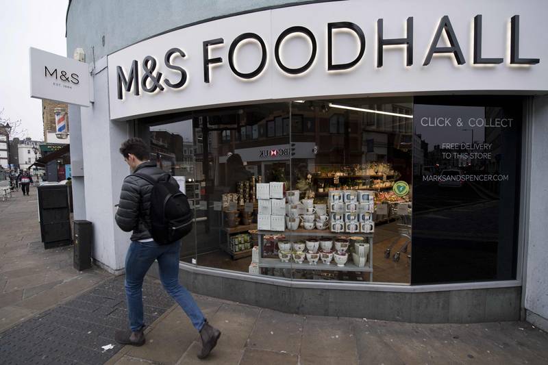 A man walks past a branch of Marks and Spencer supermarket in west London. AFP