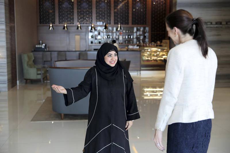 DUBAI , UNITED ARAB EMIRATES , January 17 – 2019 :- Heba Sayed , security supervisor ( left ) speaking to the guest at The Radisson Blu hotel in Business Bay area in Dubai. The Radisson Blu Hotel Dubai Waterfront has banned its staff from calling guests Sir and Madam. (Pawan Singh / The National ) For News. Story by Gillian Duncan