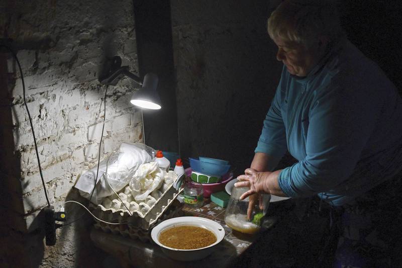 A Ukrainian woman in the basement of a building used as bomb shelter in Soledar, Donetsk region. AP