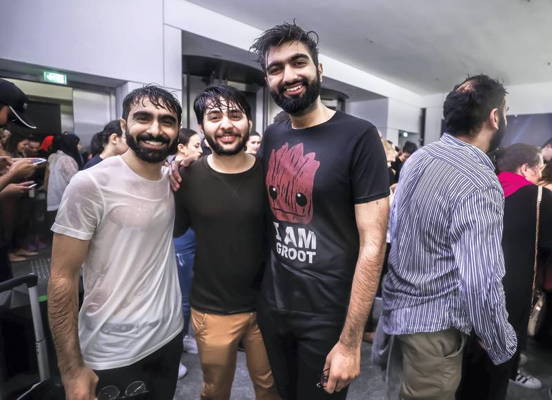 Abu Dhabi, U.A.E., November 12, 2018.  Cancelled concert of Dua Lipa at the Louvre due to a sudden downpour and gusty winds.  Concert goers take refuge at the Louvre Museum area.  (L-R) Anas J., Aizaz A. and Waleed H.Victor Besa / The NationalSection:  NAReporter: