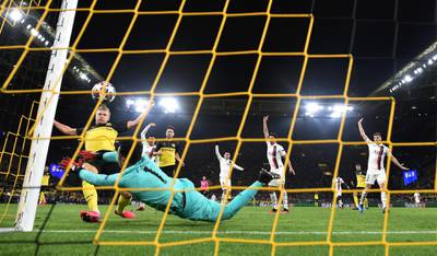 DORTMUND, GERMANY - FEBRUARY 18: Erling Haaland of Borussia Dortmund scores his team's first goal past Keylor Navas of Paris Saint-Germain during the UEFA Champions League round of 16 first leg match between Borussia Dortmund and Paris Saint-Germain at Signal Iduna Park on February 18, 2020 in Dortmund, Germany. (Photo by Stuart Franklin/Bongarts/Getty Images)
