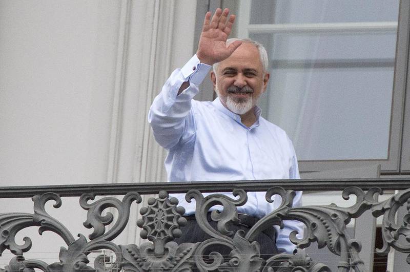 Iranian foreign minister Mohammad Javad Zarif waves from a balcony of the Palais Coburg Hotel where the Iran nuclear talks meetings are being held in Vienna. Joe Klamar / AFP