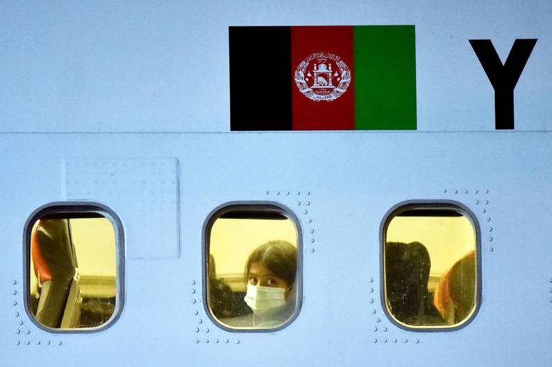 A passenger looks through the window of a plane carrying people fleeing Afghanistan, at Boryspil International Airport outside Kiev. AFP
