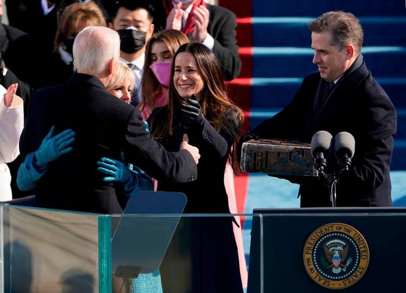 President Joe Biden is congratulated by First lady Jill Biden and children Ashley and Hunter after being sworn-in during the 59th Presidential Inauguration on January 20, 2021, at the US Capitol in Washington, DC. / AFP / POOL / Patrick Semansky
