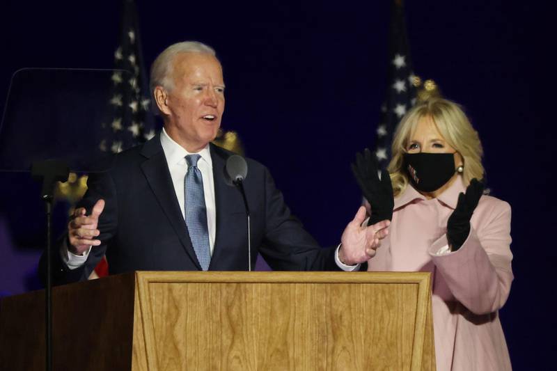 Democratic presidential nominee Joe Biden speaks at a drive-in election night event as Dr. Jill Biden looks on at the Chase Center in Wilmington, Delaware. AFP
