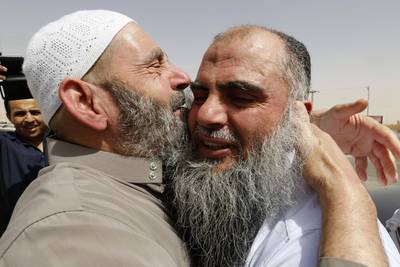 Radical Muslim cleric Abu Qatada, right, hugs his father after being released from prison after a Jordanian court acquitted him of providing spiritual and material support for a plot to attack tourists during Jordan's New Year celebrations in 2000. Muhammad Hamed/Reuters