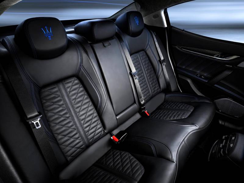 The Hybrid version has a blue-tinted badge, while the cabin's leather features blue stitching and embroidery throughout 