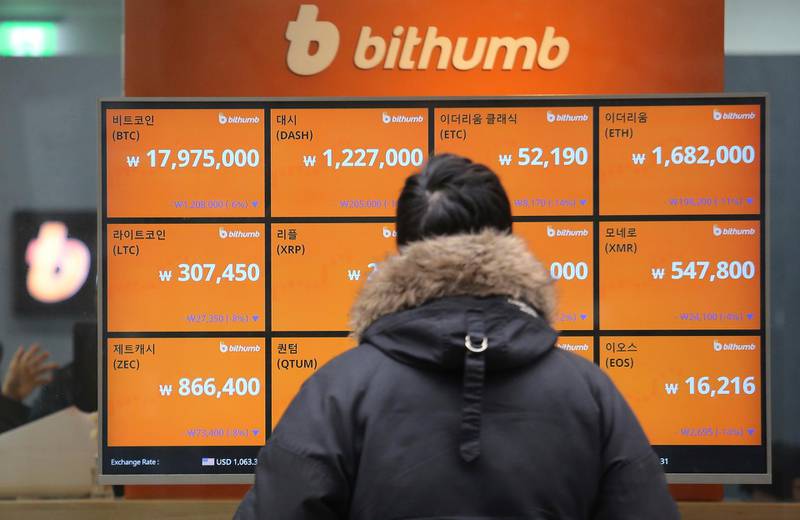 FILE - In this Tuesday, Jan. 16, 2018, file photo, a man watches a screen showing the prices of bitcoin at a virtual currency exchange office in Seoul, South Korea. Bitcoin is suffering another one of its trademark nosedives on Wednesday. The digital currency has fallen about 30 percent during the week as investors worry that regulators in South Korea will crack down on trading. (AP Photo/Ahn Young-joon, File)
