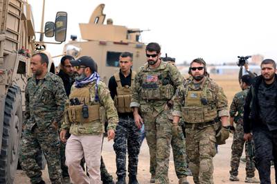 FILE PHOTO: Syrian Democratic Forces and U.S. troops are seen during a patrol near Turkish border in Hasakah, Syria November 4, 2018. REUTERS/Rodi Said/File Photo