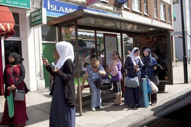 British Muslim women wait at a bus stop in the district of Tooting, London. For the first time since records began, white Britons make up less than half of London’s ethnic mix.