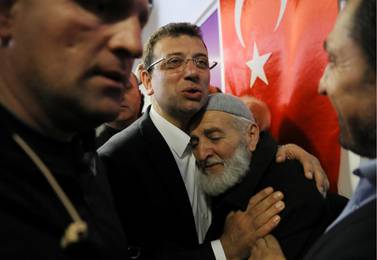 Ekrem Imamoglu, main opposition Republican People's Party (CHP) candidate for mayor of Istanbul, embraces his supporter at his election campaign office in Istanbul. Reuters