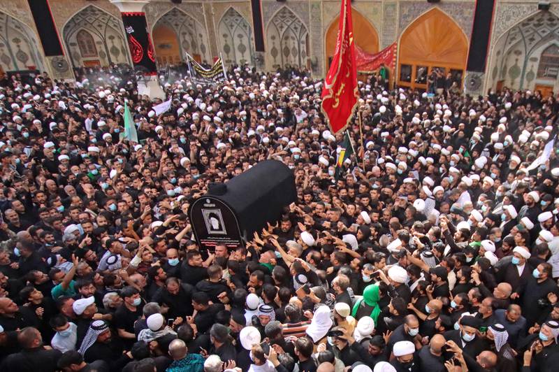 Iraqis carry the coffin of Mohammed Saeed Al Hakim during his funeral in Najaf. AFP