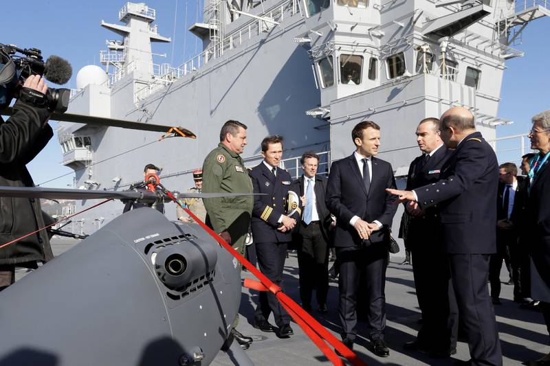 French President Emmanuel Macron attends the presentation of drone on the deck of the French war ship Dixmude docked in the French Navy base of Toulon, southern France, after delivering a speech to present his New Year's wishes to the French Army, January 19, 2018. REUTERS/Claude Paris/Pool