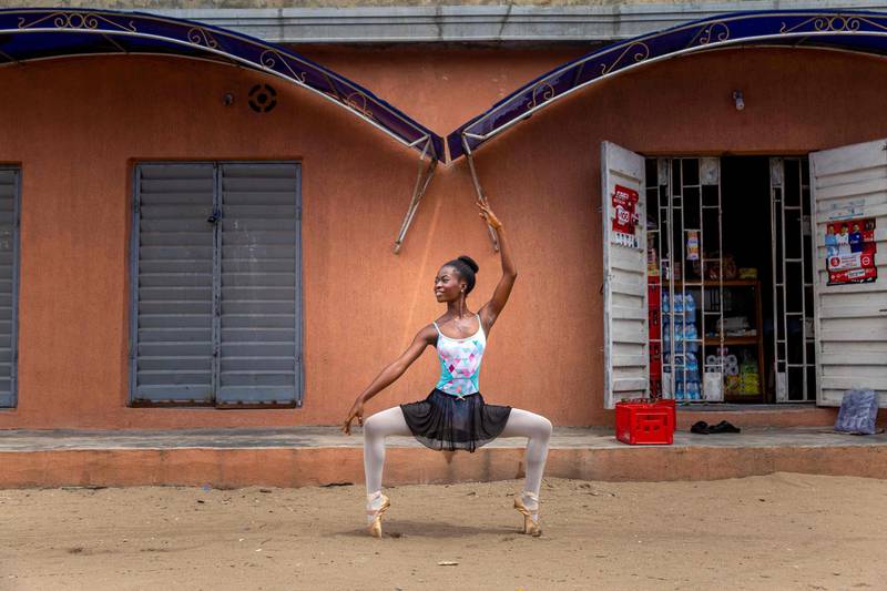 A student of the Leap of Dance Academy, Olamide Olawale, performs a dance routine in Okelola street in Ajangbadi, Lagos. AFP