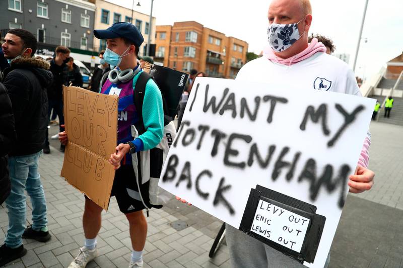 A Tottenham fan holds up a sign before the match. EPA