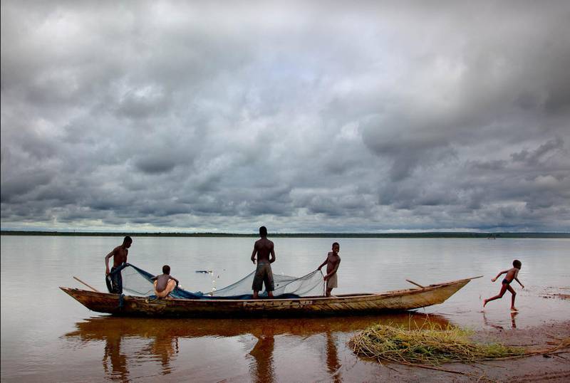 'Fishing Boats' by Kristine, taken in Lake Volta. She says, "The youngest child on this boat is 7; the oldest is 15. It is the end of the day. They have been working since 4am... The nets can weigh as much as 1,000 pounds when they are full."