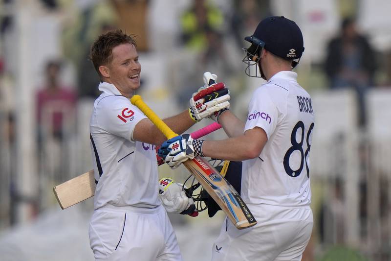 England's Ollie Pope, left, celebrates with teammate Harry Brook after reaching his century. AP