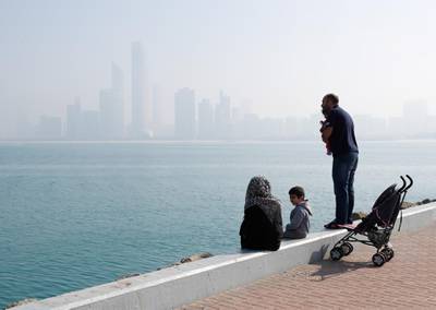 Abu Dhabi, U.A.E., February 8, 2018.  Fog at The Corniche UAE flag area.  A couple and their children enjoy the Abu Dhabi, sunny but chilly weather.  Victor Besa / The NationalNational