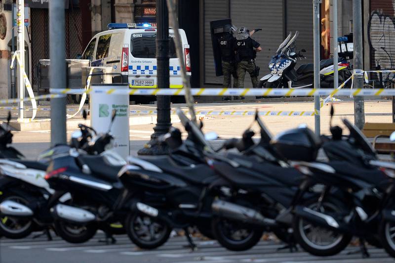 Armed policemen stand in a cordoned off area after a van ploughed into a crowd. Josep Lago / AFP.