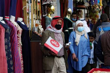 People wearing protective masks walk in downtown Amman. Reuters