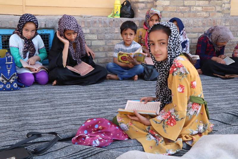 Children read the Quran at a Mosque  in Herat, Afghanistan.  EPA
