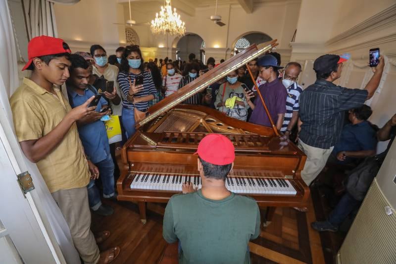 People sing songs inside the prime minister's official residence. EPA