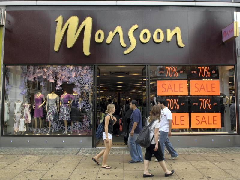General view of shoppers walking past a Monsoon store on Oxford Street in London.