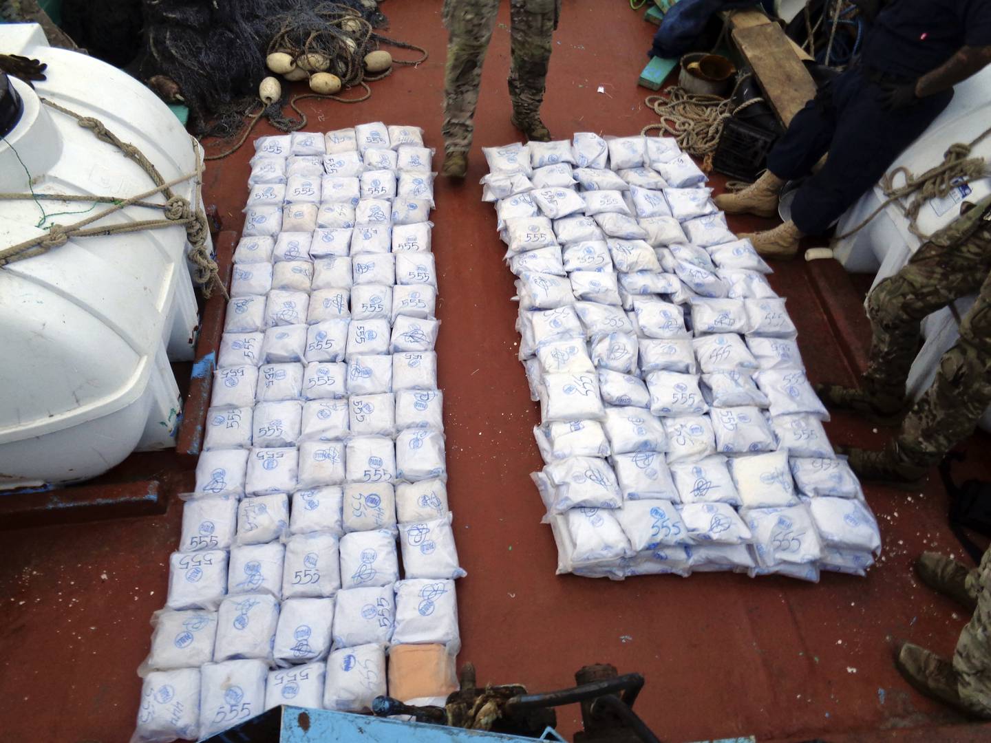 US Navy personnel from the USS Tempest and USS Typhoon gather the confiscated illegal drugs. AP