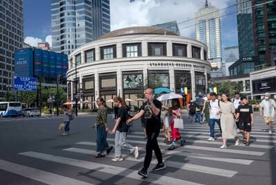 Pedestrians in central Shanghai. China's central bank has cut key policy rates for the second time since June in a bid to revive sagging economic growth. EPA