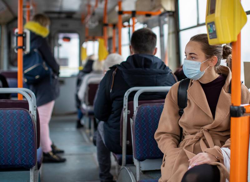 A woman wears a face masks on a bus journey in Vilnius, Lithuania. AP Photo
