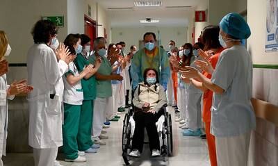 Elsa, a Covid-19 patient who was has been in hospital for 315 days, is applauded as she is discharged from the hospital in Madrid, Spain. EPA