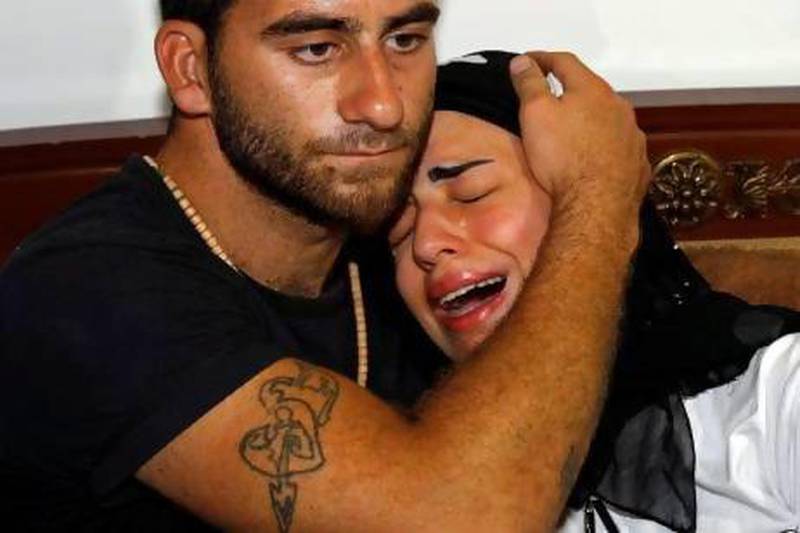 Fatima, right, daughter of Mohammed Jammo, is comforted by a relative. Jammo’s Lebanese wife and daughter were both in the house when he was shot.