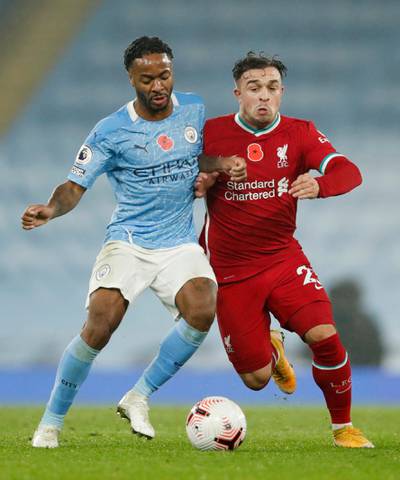 Liverpool's Xherdan Shaqiri battles for possession with Raheem Sterling of City. Reuters