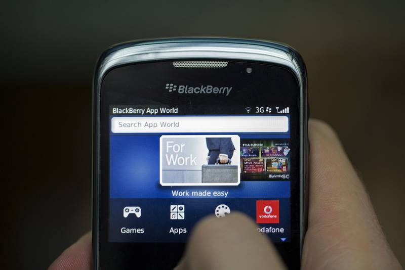 The BlackBerry App World logo is seen on the screen of a BlackBerry Curve smartphone, produced by BlackBerry Ltd., in this arranged photograph taken in London, U.K., on Monday, Sept. 23, 2013. BlackBerry said yesterday it reached a tentative agreement for a $4.7 billion buyout by a group led by Fairfax Financial Holdings Ltd., its biggest shareholder. Photographer: Simon Dawson/Bloomberg