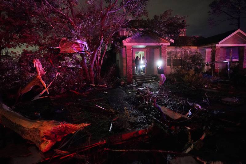 Standing on the porch of a damaged home in the aftermath of the tornado. AP Photo