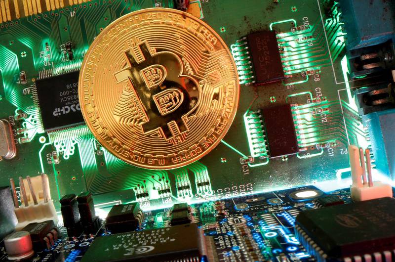 FILE PHOTO: Representation of the virtual currency Bitcoin is seen on a motherboard in this picture illustration taken April 24, 2020. REUTERS/Dado Ruvic /Illustration/File Photo