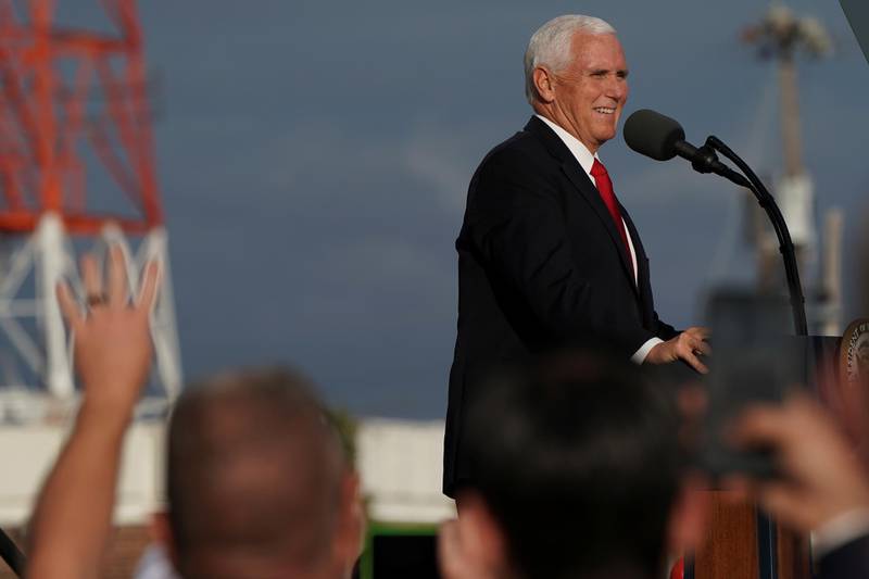 An attendee holds up fingers indicating 'four more years' as U.S. Vice President Mike Pence speaks at a campaign event with Senator David Perdue in Savannah, Georgia, U.S., December 4, 2020.  REUTERS/Elijah Nouvelage