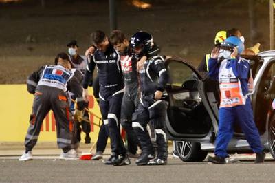 Haas' Romain Grosjean is taken away by medical officers after his crash in Bahrain on Sunday. Reuters