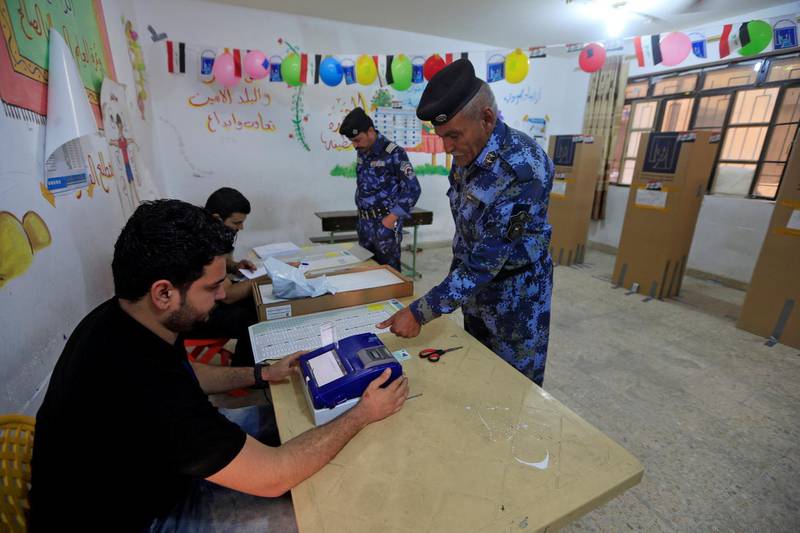 An Iraqi security member casts his vote at a polling station in Najaf, Iraq. Alaa al-Marjani / Reuters
