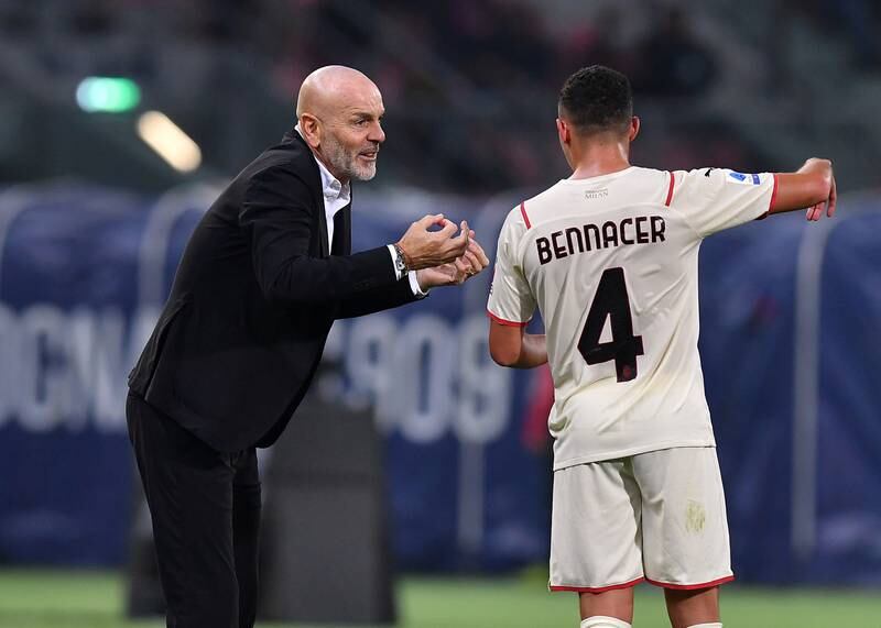 AC Milan coach Stefano Pioli speaks to Ismael Bennacer during the match. Reuters