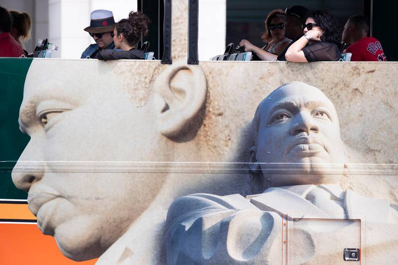 People ride on a tour bus that depicts the Stone of Hope at the Martin Luther King Jr Memorial at Union Station in Washington, DC. EPA