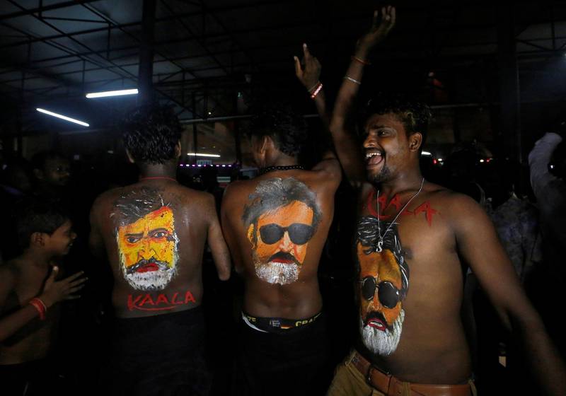 Fans with their bodies painted with images of actor Rajinikanth dance as they celebrate the release of his new movie "Kaala" in Mumbai, India, June 7, 2018. REUTERS/Francis Mascarenhas